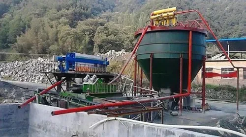 Filter press and associated slurry treatment equipment at an outdoor site
